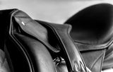 a dressage saddle with a girth